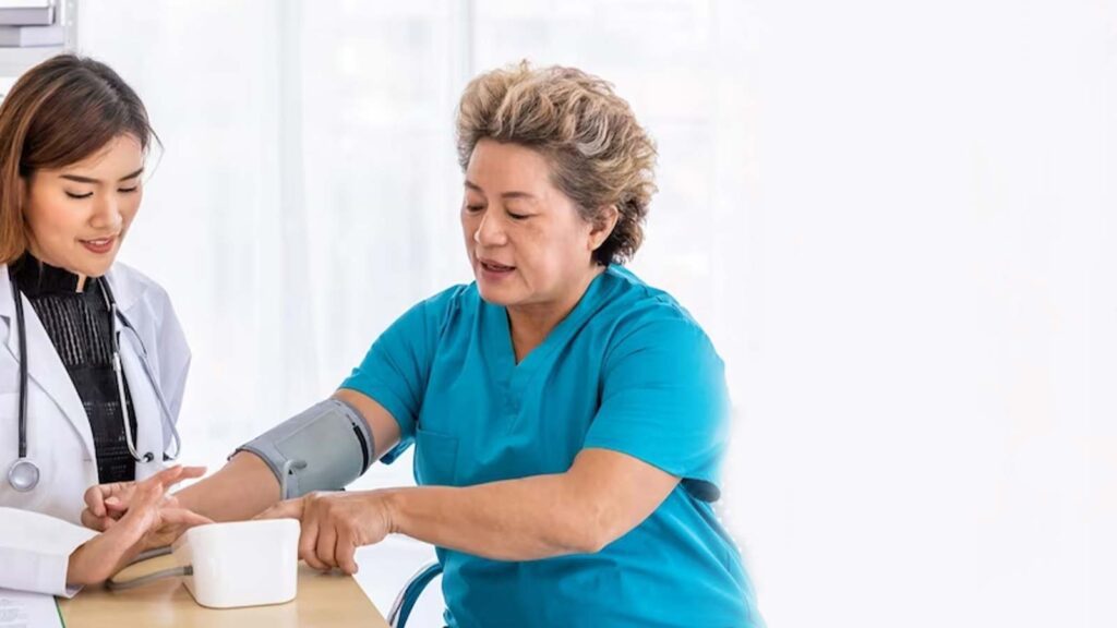 A healthcare worker checks a patient's blood pressure, a routine part of high blood pressure service in chicago urgent care, emphasizing the importance of cardiovascular health monitoring.