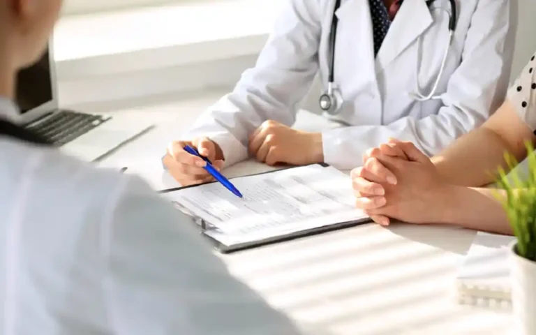 Doctor reviewing patient records for prescription renewal