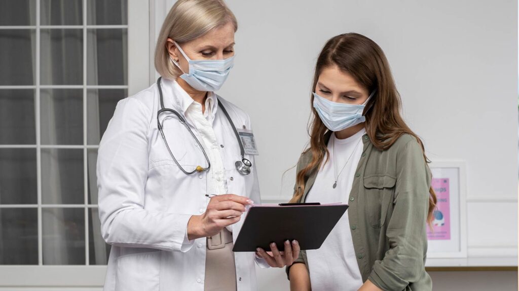 A doctor and patient review a document, likely discussing an abnormal pap smear pressure service in Chicago urgent care, ensuring timely medical attention.