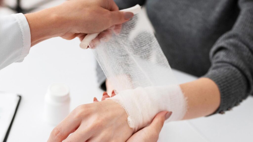 A healthcare provider expertly wraps a patient's wrist, a routine procedure in injuries treatment in chicago urgent care for sprains and minor injuries.