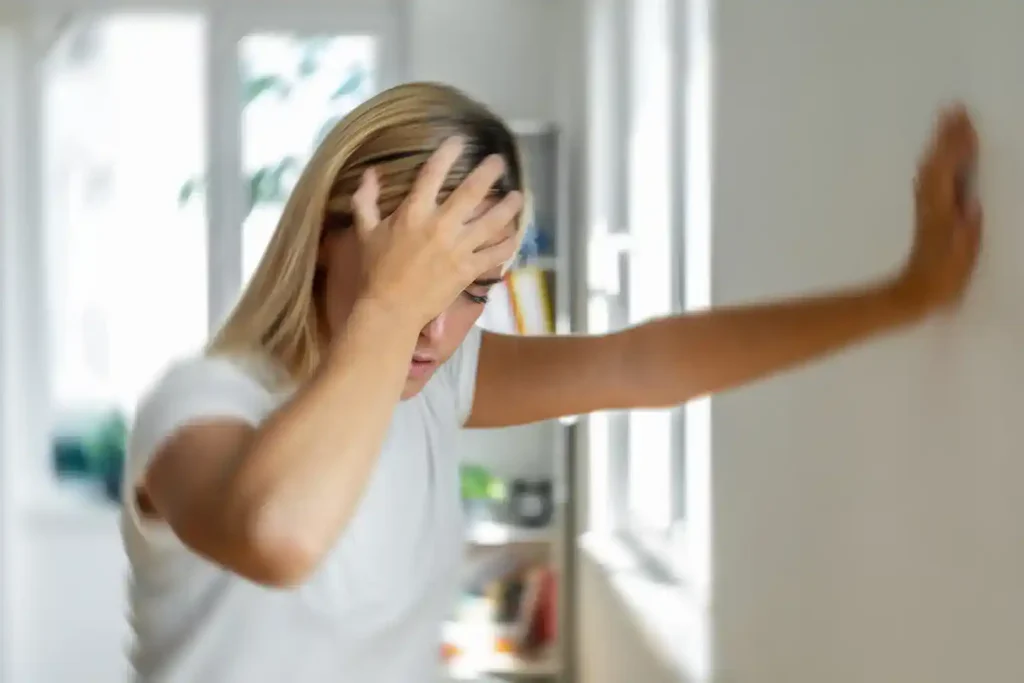 Woman holding face in discomfort from chronic sinusitis