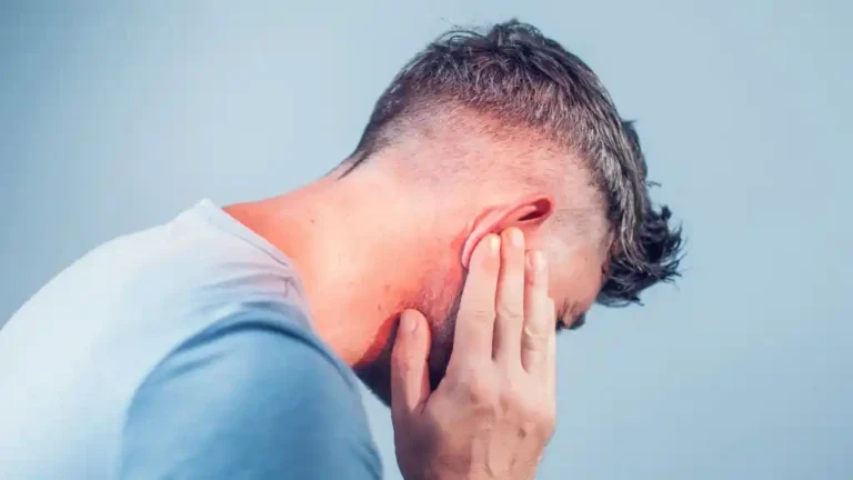 man holding her ear and jaw in pain due to ear infection