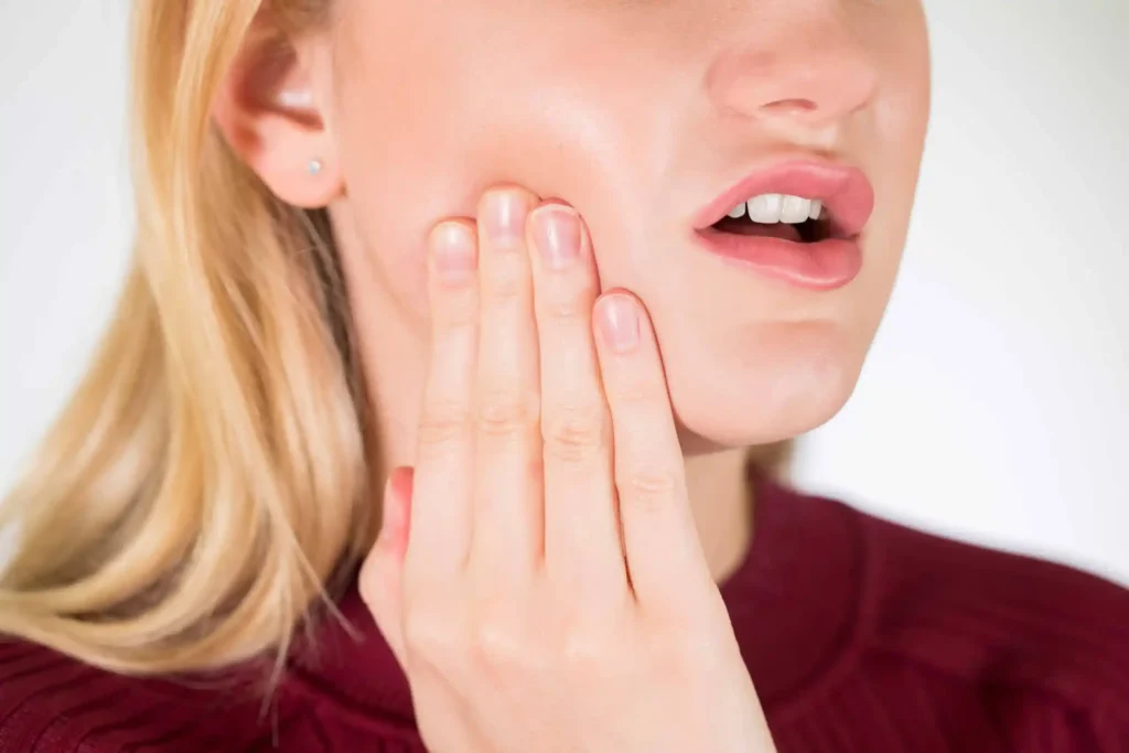 Patient holding side of face due to ear and jaw pain